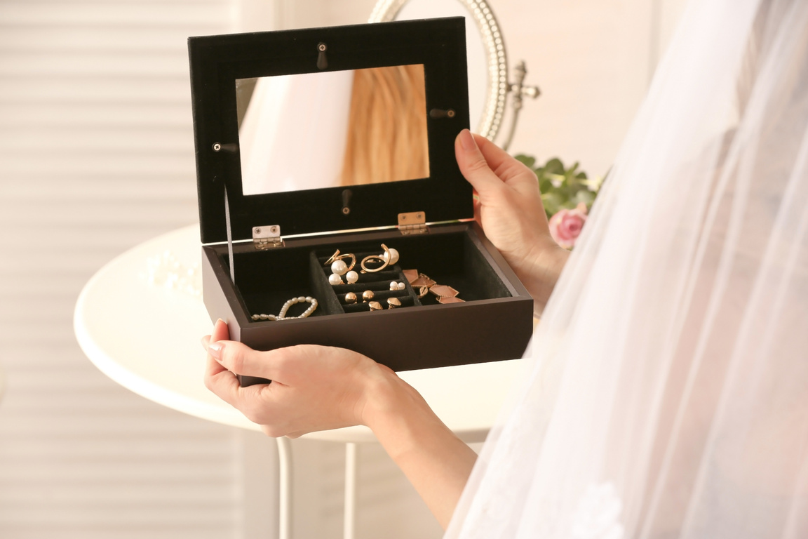 Bride Holding Jewelry Box on Table